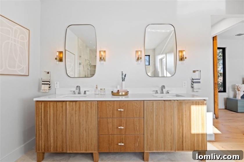 An elegantly tiled shower with modern fittings, showcasing the high-quality materials and craftsmanship employed by 5West Homes.
