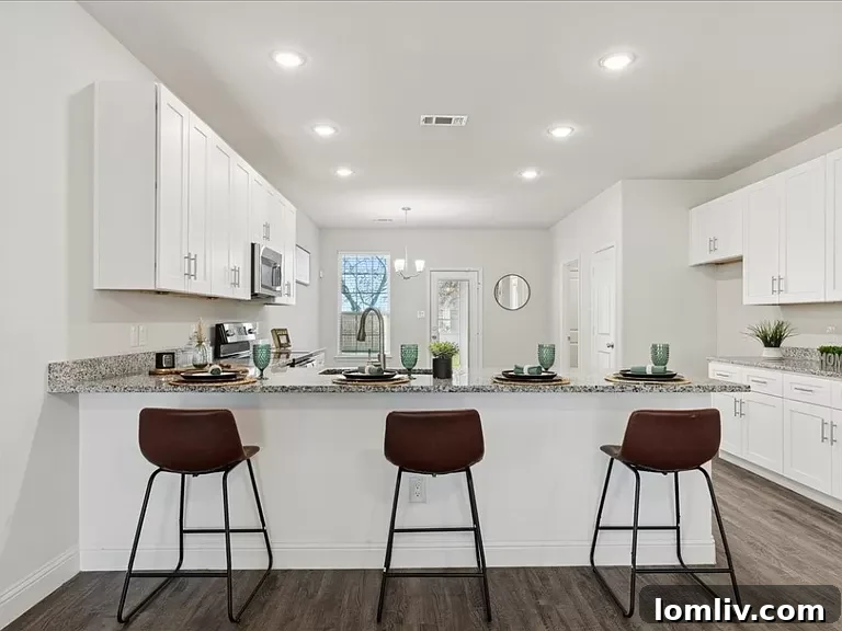A modern kitchen with a breakfast bar, granite countertops, and recessed lighting.