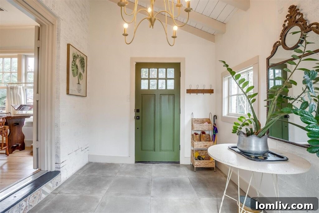 Inviting green entry door leading into the vestibule of a historic Fort Worth bungalow.