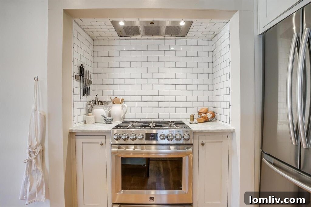 Close-up of the stylish kitchen range set into a tiled niche, highlighting quality appliances.