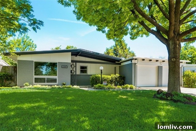 Elegantly restored Midcentury Modern home exterior, showcasing its distinctive architectural lines and refreshed curb appeal with lush landscaping.