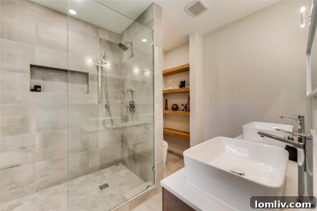 Luxurious primary bathroom featuring high-end fixtures, custom vanity, and elegant tiling, a true showstopper of design.