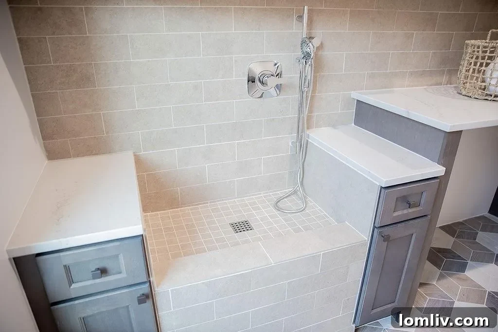 Detail of the dual vanities and backlit mirrors in the spa-like primary bathroom of the Hideaway Lake home