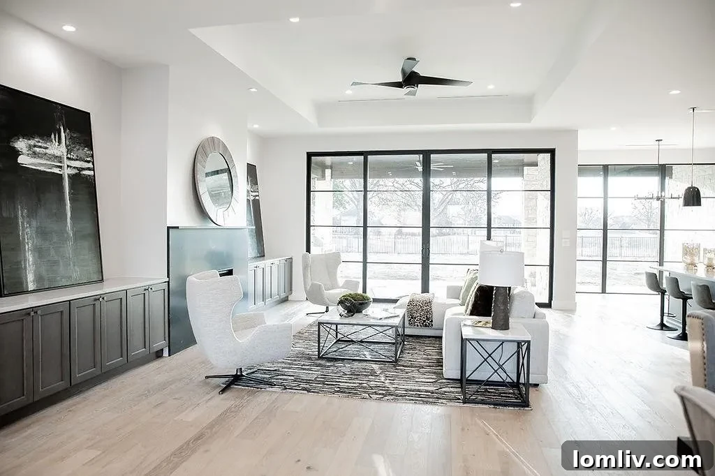 Spacious living room at 94 Ryder Cup Trail with a modern fireplace, built-in cabinetry, and large windows