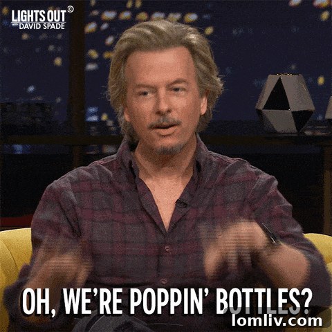 The Bottle House with a vibrant blue sky background, showcasing the textural contrast between smooth glass bottles and rugged stone walls.