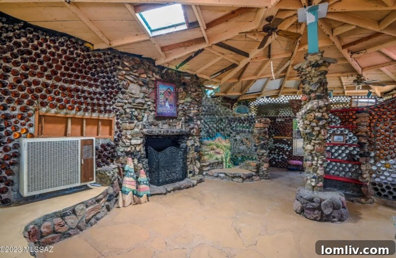 Another interior shot, highlighting the artistic arrangement of different colored bottles within the wall structure, illuminated by natural light.