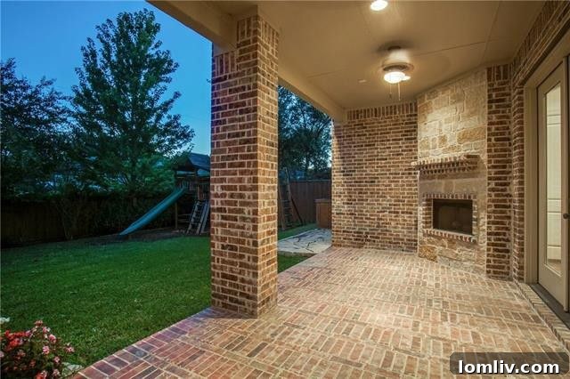 Covered outdoor patio with a fireplace, perfect for year-round entertaining and relaxation