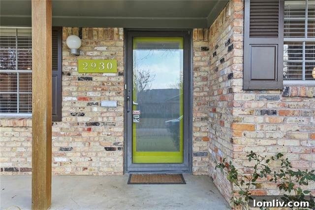 Spacious living room featuring a floor-to-ceiling brick fireplace