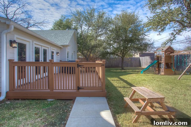 Spacious backyard at 6110 Locke Avenue with privacy fence, electric gate, and deck