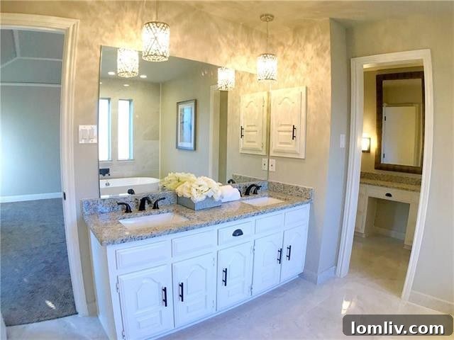 Inviting master bedroom with a tray ceiling and abundant natural light, creating a serene ambiance