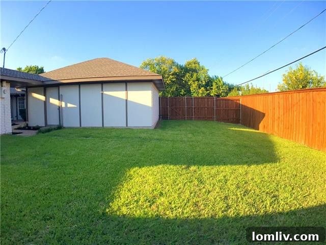 Spacious fenced backyard with mature trees and ample room for outdoor activities at 16114 Fallkirk Drive