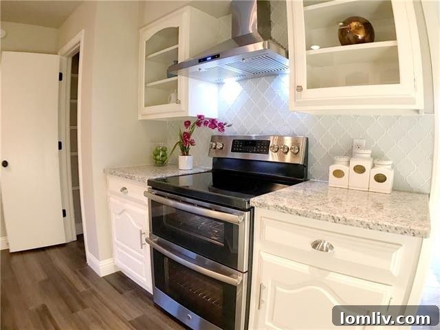 Luxurious master bathroom with a freestanding tub, dual vanity, and elegant tilework