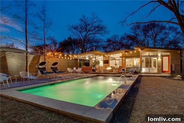 Evening view of the illuminated pool and outdoor living space, creating an inviting ambiance