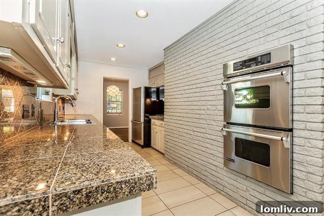 Updated kitchen with granite countertops and stainless steel appliances