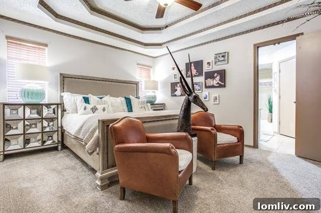 Luxurious master bathroom with double vanity and contemporary tiling.