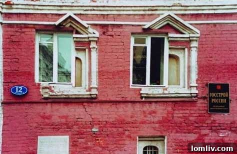 House exterior showcasing a new, square window ungracefully fitted into an older, arched window frame, clashing with the home's style.