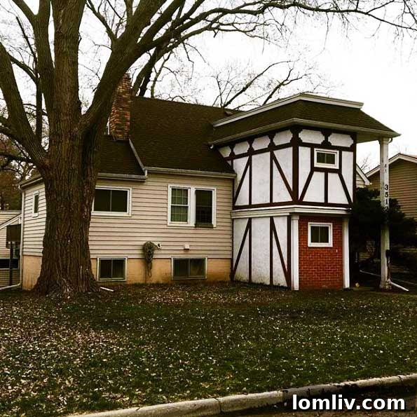 House exterior showcasing a bizarre blend of Tudor architectural elements with other conflicting styles, creating an unharmonious look.