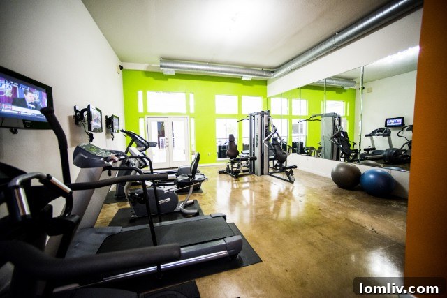 Premier Dallas Apartment Gyms 11 Spacious gym with a variety of fitness machines at Trinity Loft Dallas.