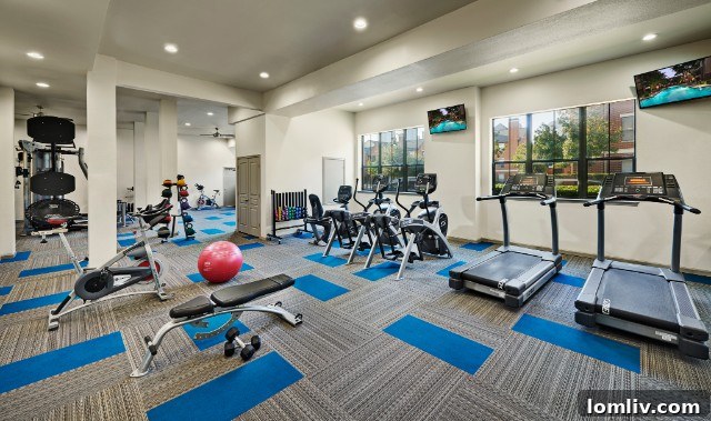Premier Dallas Apartment Gyms 3 Spacious gym with cardio machines at Camden Farmers Market apartments.