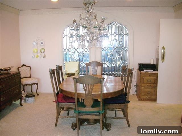 The enclosed dining area in Unit 1313, showing the wall separating it from the front door and the doorway leading to the kitchen, with a mirrored window reflecting the living room.