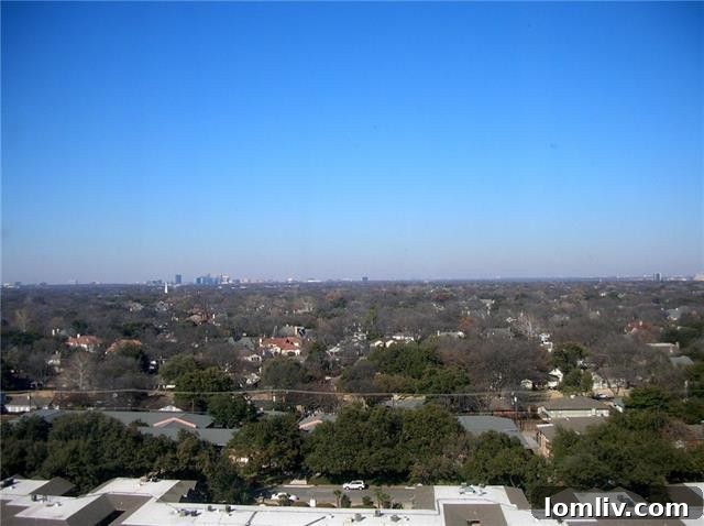 View from Unit 1313's balcony or window, looking north towards the Galleria area of Dallas, showing the potential for an outdoor living space.