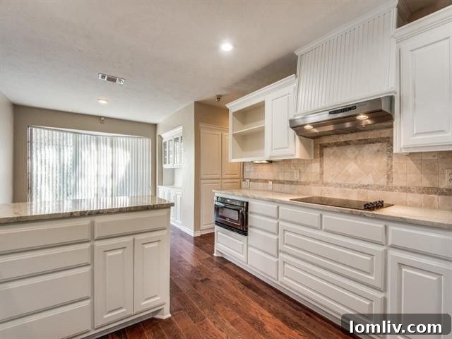 Spacious master bathroom with dual vanities, elegant fixtures, and contemporary soaker tub