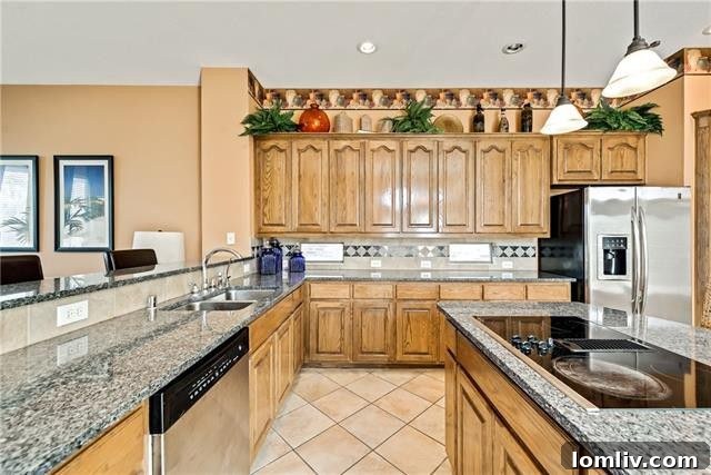 Functional kitchen with center island, granite countertops, and stainless steel appliances
