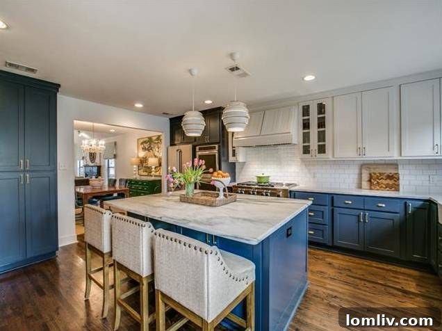 Wide view of the modern kitchen, showing the island and ample workspace.