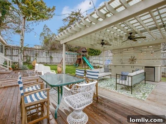 Aerial view of the stunning backyard featuring a gunite pool, pergola, and spacious lawn.