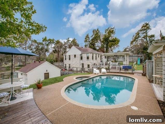The sparkling resurfaced gunite pool with a clear safety fence installed.