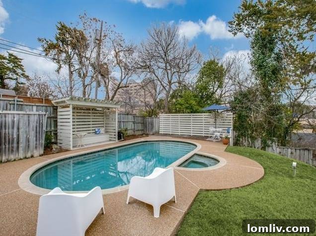 Expansive green lawn and mature landscaping framing the outdoor entertainment areas.
