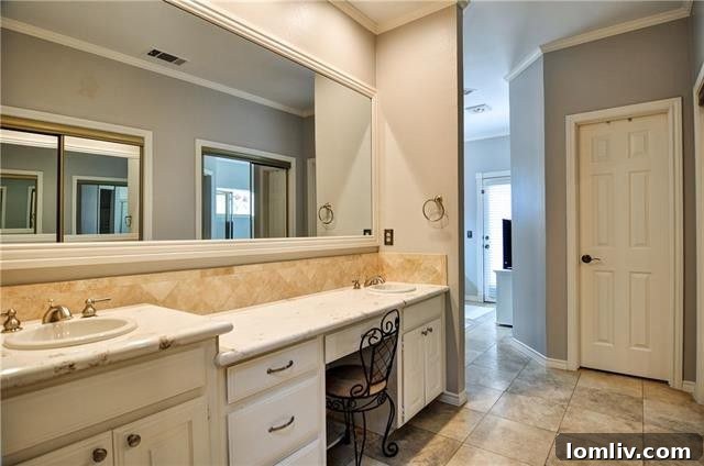 Updated master bathroom featuring a jetted tub and modern amenities