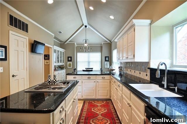 Updated eat-in kitchen with vaulted-and-beamed ceiling and stainless appliances