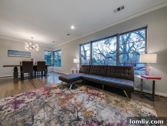 Spacious and bright living room at 9606 Losa with views of the lush garden
