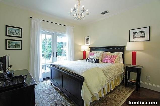 Guest bedroom or secondary master suite with French doors leading to the patio and pool