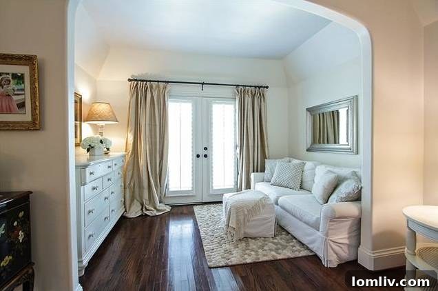 Bright master bedroom with a dedicated sitting area overlooking the backyard