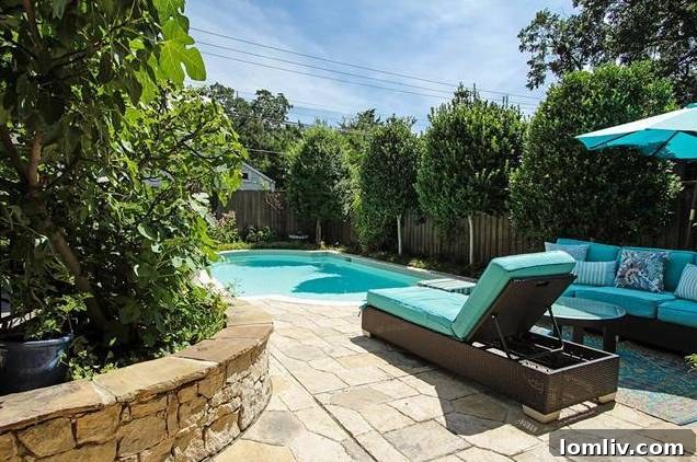 Side view of the Tudor home showcasing its architectural details and well-maintained garden