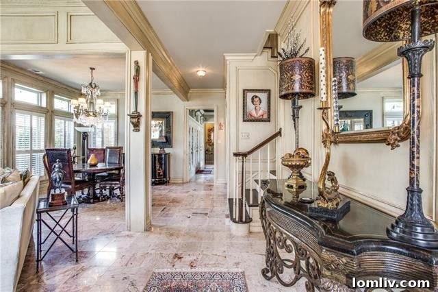 Bright living space with large windows and traditional wall paneling