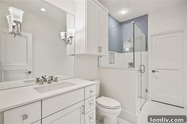 Guest bathroom with a frameless glass shower and designer finishes.