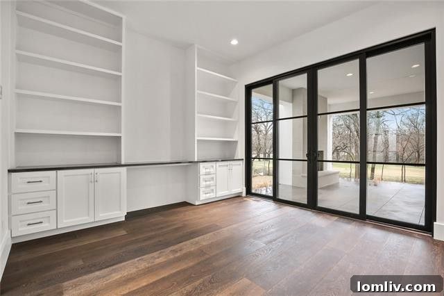 Downstairs study with custom built-in desk and shelves in a luxury Dallas home.
