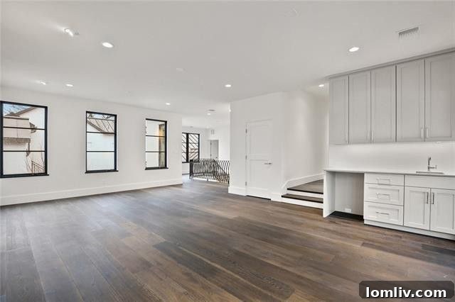 Oversized upstairs game room/family room with wet bar, ideal for entertainment.