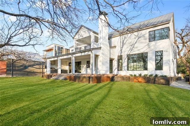 Expansive outdoor living area with fireplace and ample space for a pool, overlooking lush scenery.