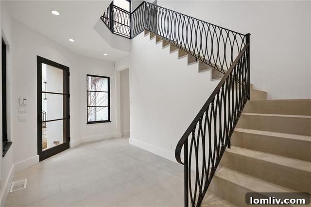 Custom wrought iron railing and limestone stairs in the courtyard of a luxury home.