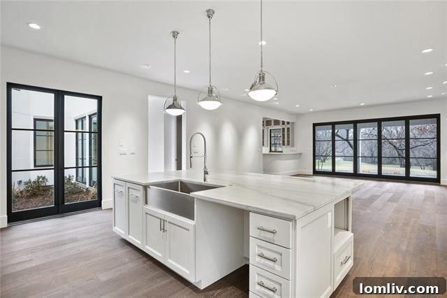 Open-concept kitchen, living, and dining area with wet bar, perfect for entertaining in a luxury Dallas home.