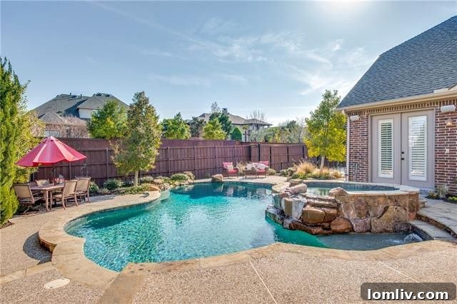 Backyard diving pool with rock spa and outdoor grilling area