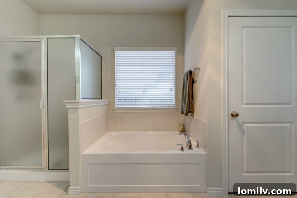Luxurious master suite with separate vanities, soaking tub, and walk-in shower at 3923 Lafayette Avenue in Arlington Heights