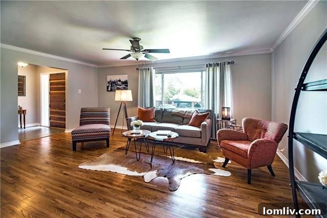 Inviting living room with refinished hardwood floors and large picture window