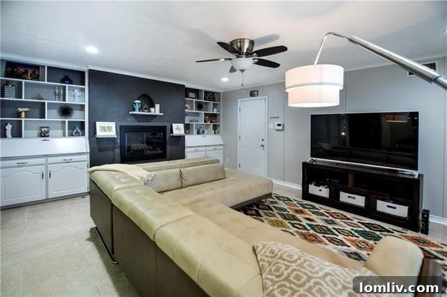Cozy family room with wood-burning fireplace and custom display cabinets