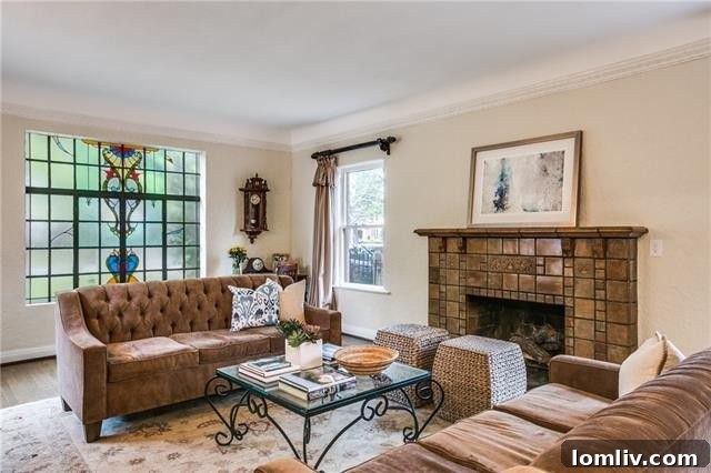 Elegant living room with fireplace and arched doorways in Hutsell home