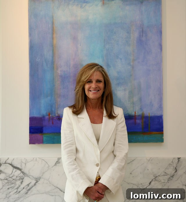 Susan Griffin of Bill Griffin Real Estate stands proudly in front of a Knox View Home